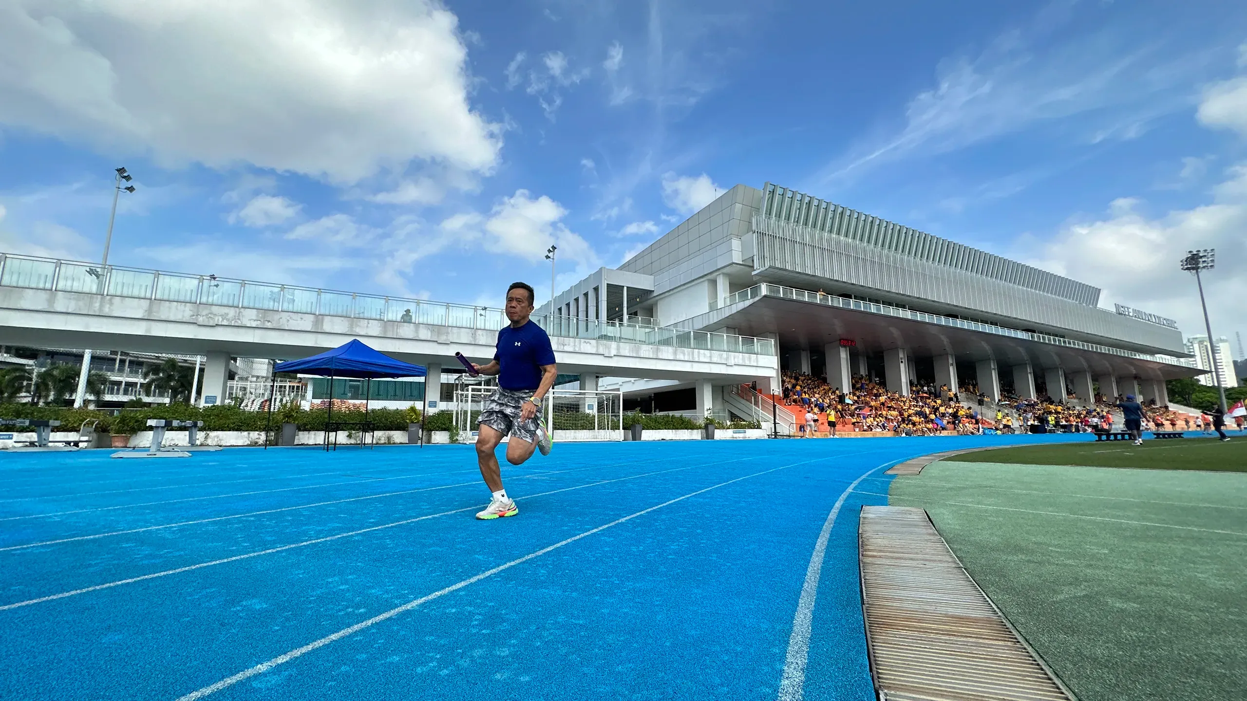 A thrilling moment from the special teacher-versus-student match a school staff sprints down the track, showcasing fierce spirit and sportsmanship at the 2023 Fairfield Sports Day.